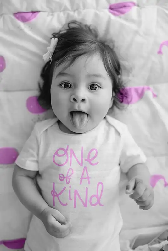 Little girl wearing a t-shirt with text one of kind