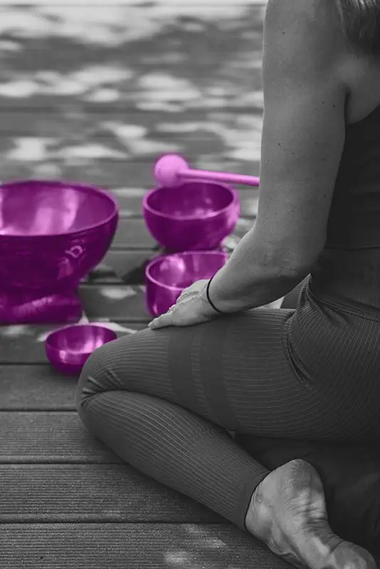 Woman playing singing bowls as a spiritual practice