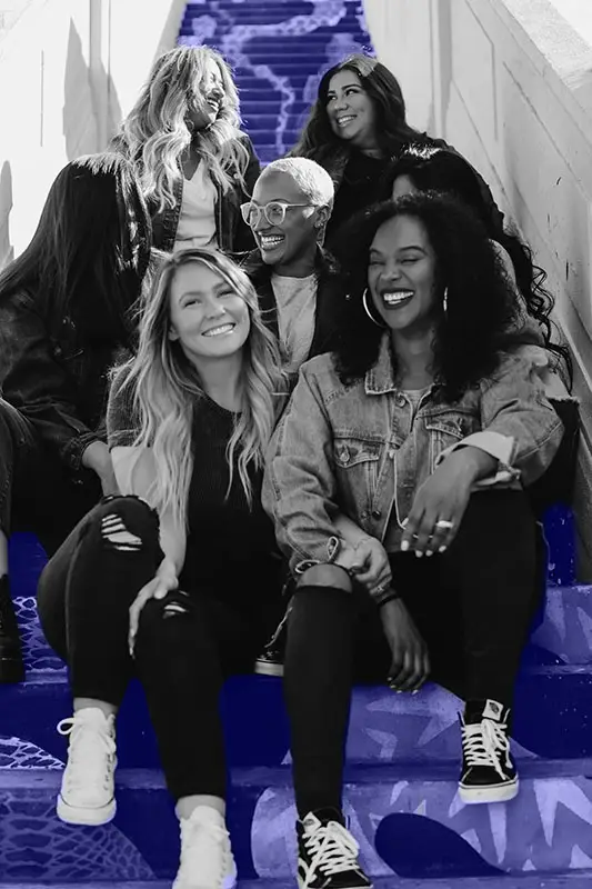 Group of young women sitting on the stairs outside