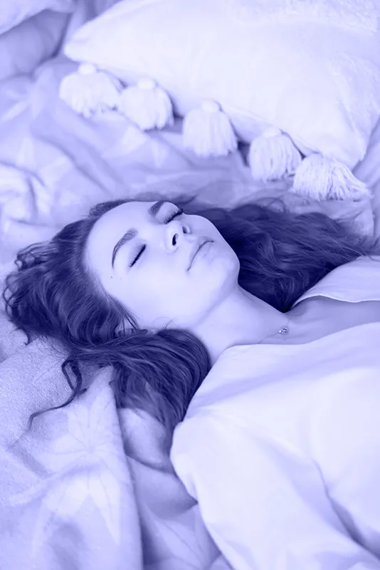 Woman meditating on bed